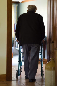 Elderly man using a Seat Walker